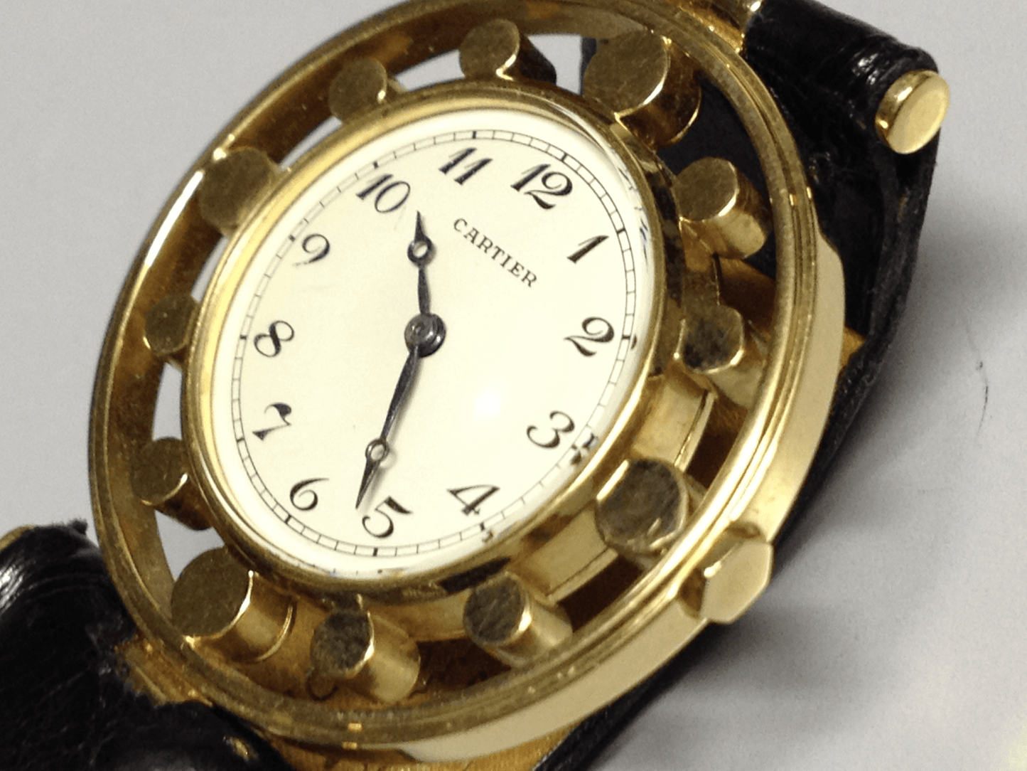 Vintage Cartier Gouvernail watch in yellow gold, circa 1960, featuring Breguet numerals, blue steel hands, and a unique cylindrical hour marker design.