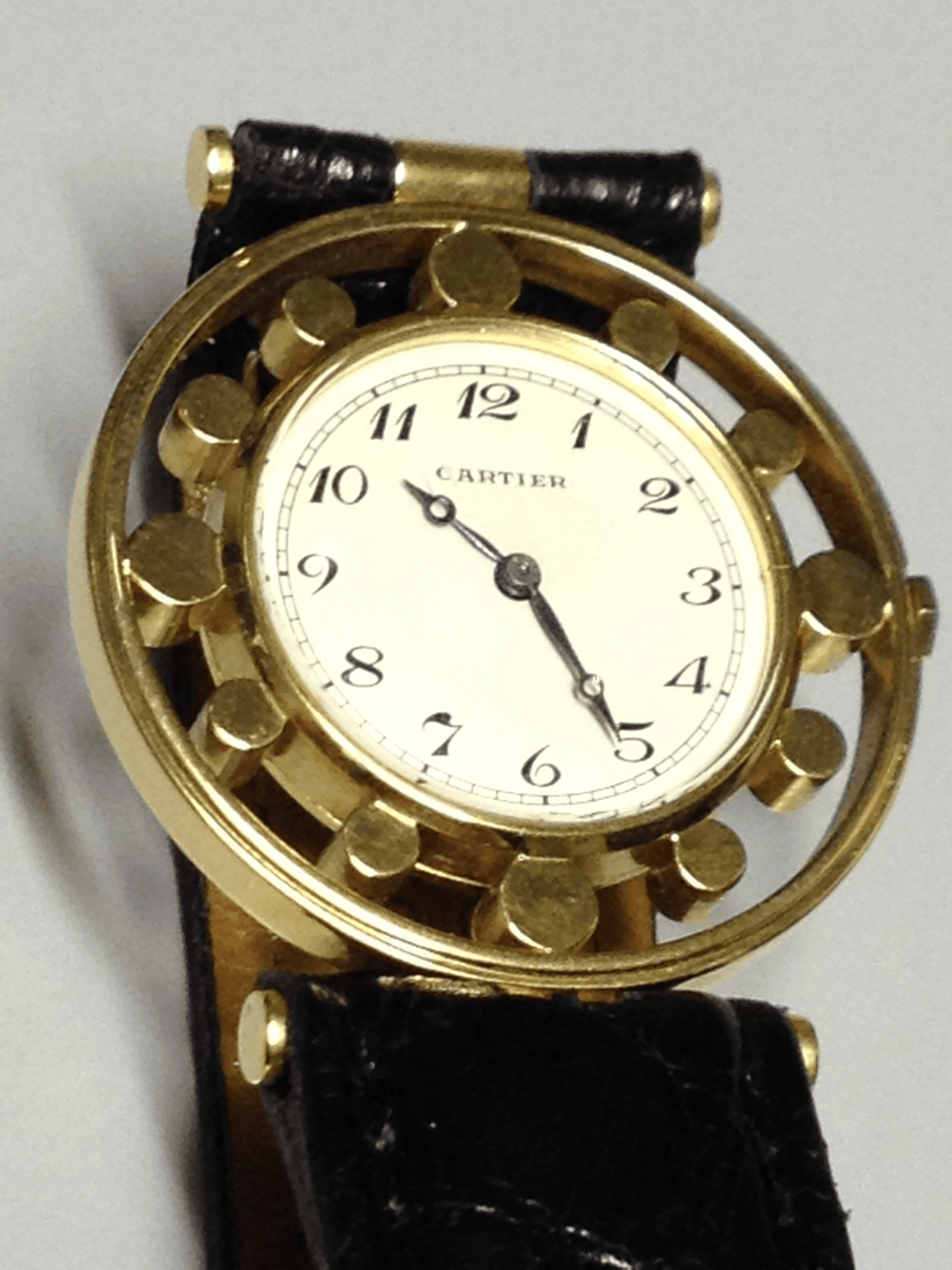 Vintage Cartier Gouvernail watch in yellow gold, circa 1960, featuring Breguet numerals, blue steel hands, and a unique cylindrical hour marker design.