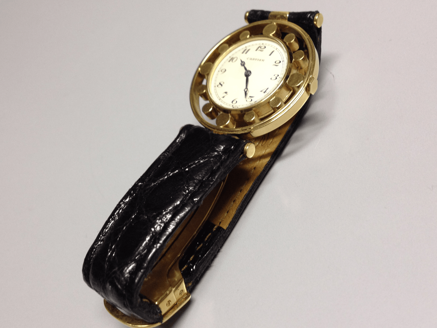Vintage Cartier Gouvernail watch in yellow gold, circa 1960, featuring Breguet numerals, blue steel hands, and a unique cylindrical hour marker design.