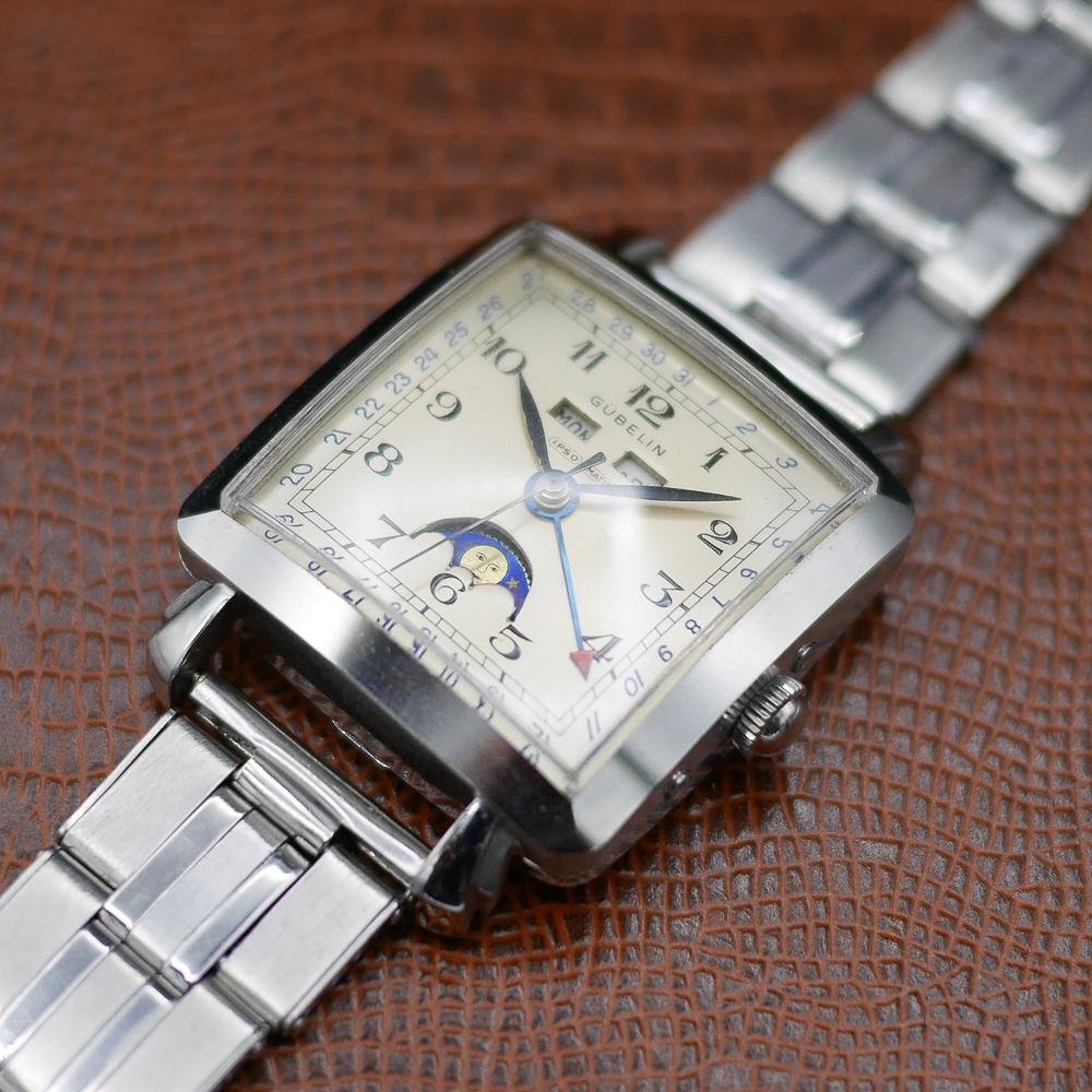 Gubelin stainless steel watch, vintage 1950, classic design, Swiss craftsmanship, timeless elegance.