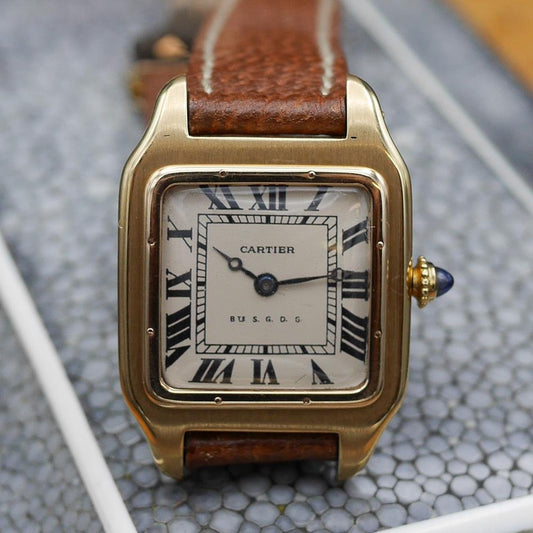 Cartier Santos in yellow gold, circa 1920, 24x34mm case, featuring classic aviation-inspired design and historical significance.