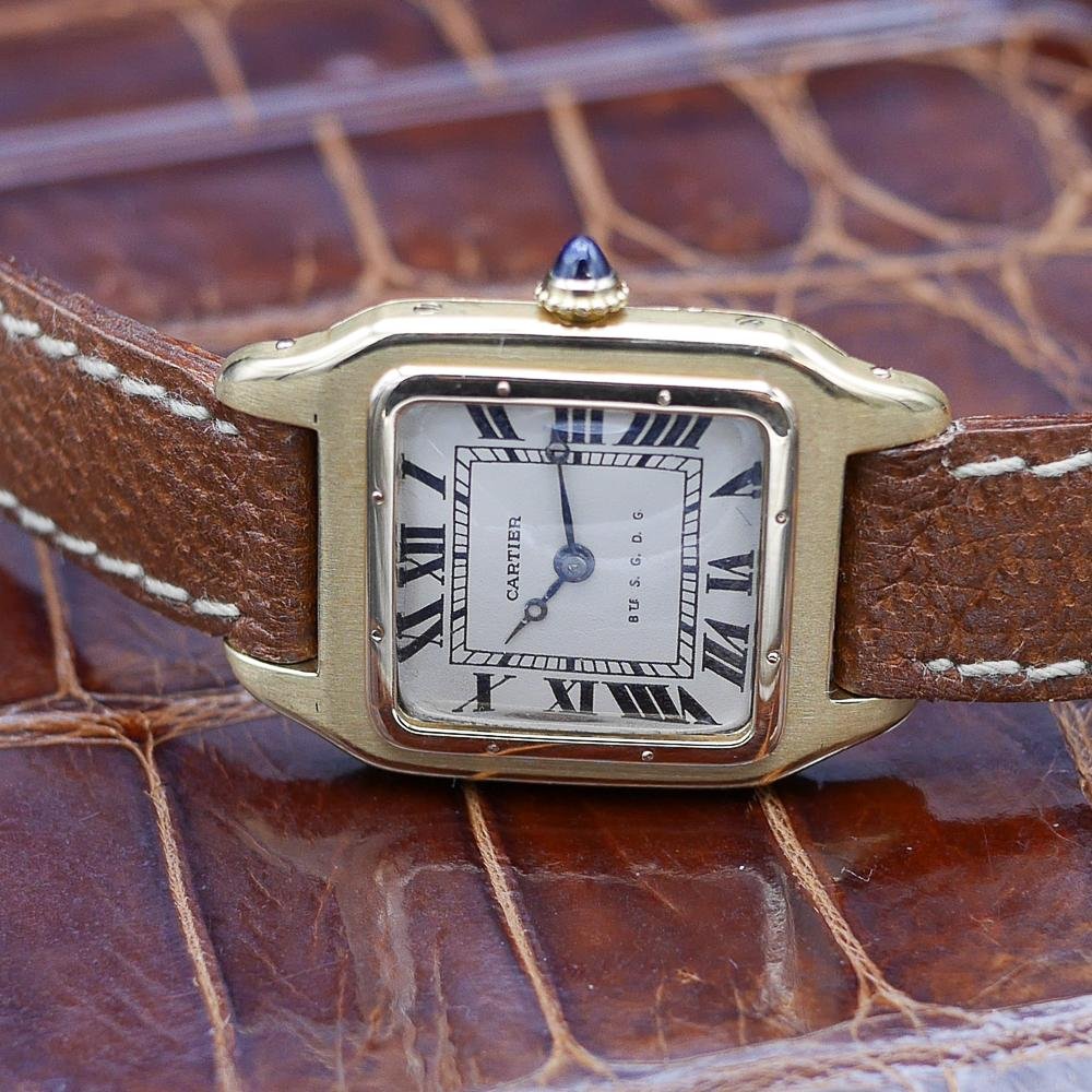 Cartier Santos in yellow gold, circa 1920, 24x34mm case, featuring classic aviation-inspired design and historical significance.
