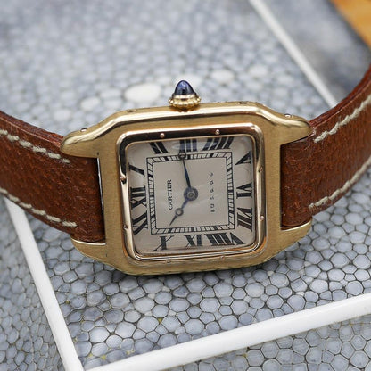 Cartier Santos in yellow gold, circa 1920, 24x34mm case, featuring classic aviation-inspired design and historical significance.