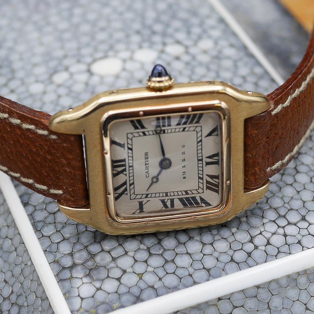 Cartier Santos in yellow gold, circa 1920, 24x34mm case, featuring classic aviation-inspired design and historical significance.