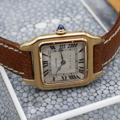 Cartier Santos in yellow gold, circa 1920, 24x34mm case, featuring classic aviation-inspired design and historical significance.