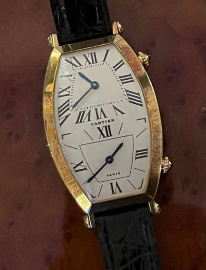 Cartier Tonneau Dual Time watch in yellow gold, REF: W1502853, from the 1990s, featuring a quartz movement and elegant dual-time display.
