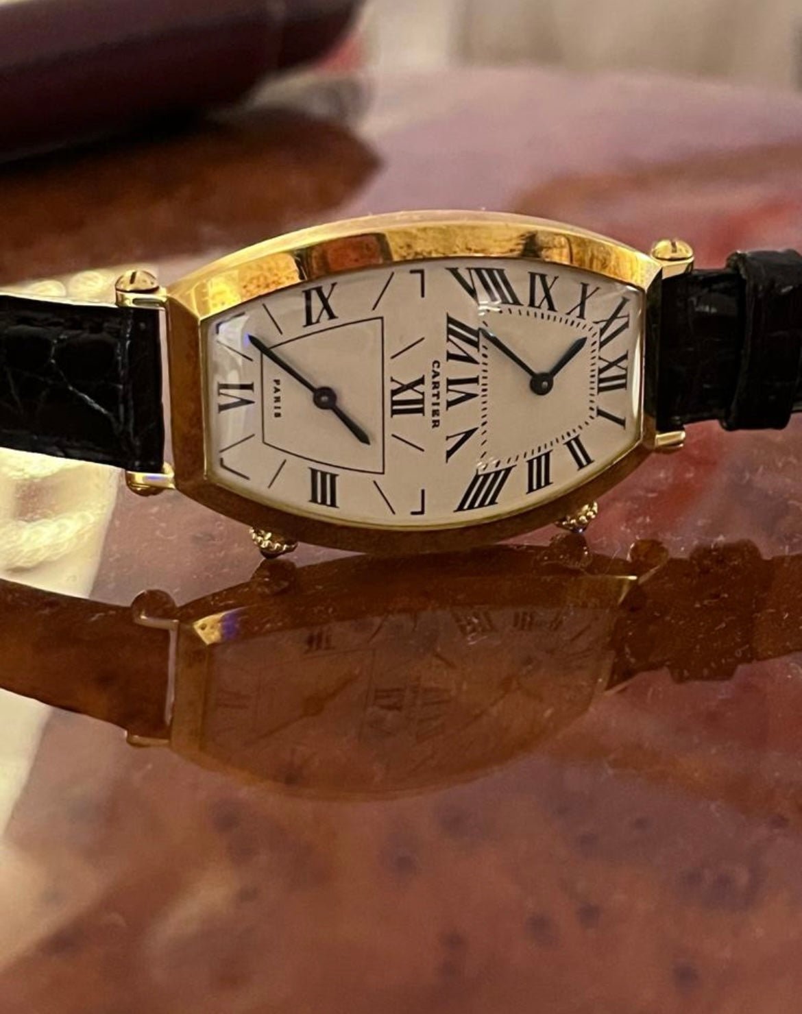 Cartier Tonneau Dual Time watch in yellow gold, REF: W1502853, from the 1990s, featuring a quartz movement and elegant dual-time display.