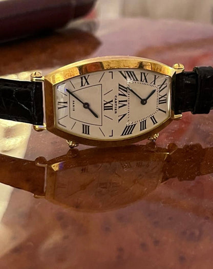 Cartier Tonneau Dual Time watch in yellow gold, REF: W1502853, from the 1990s, featuring a quartz movement and elegant dual-time display.