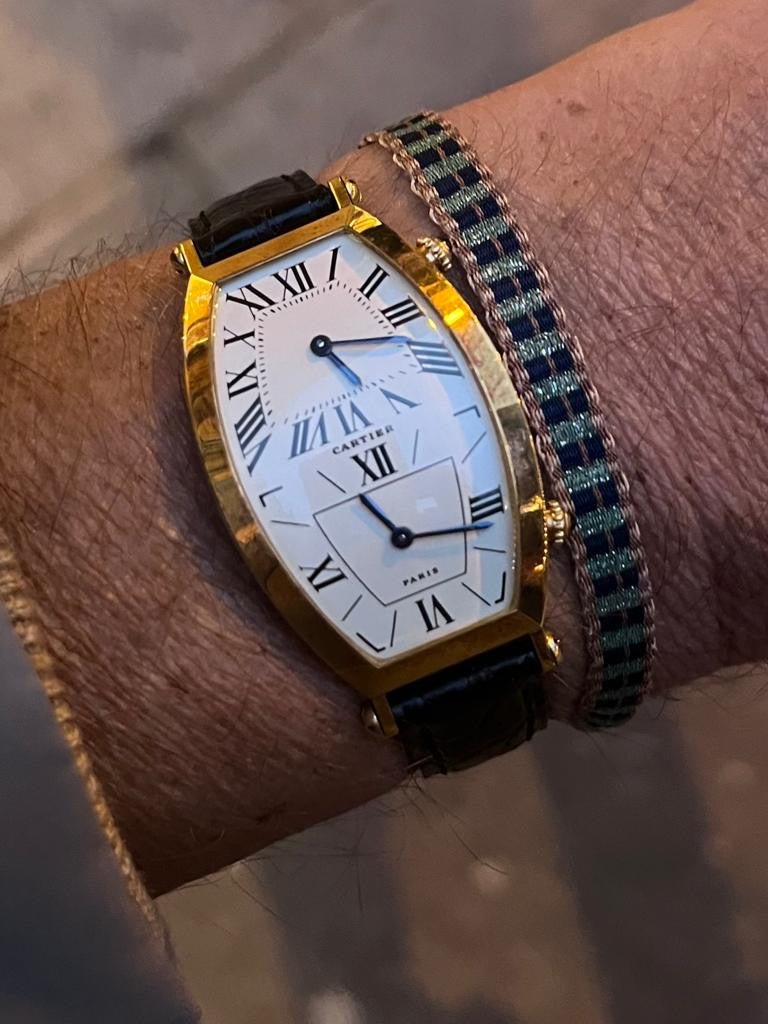 Cartier Tonneau Dual Time watch in yellow gold, REF: W1502853, from the 1990s, featuring a quartz movement and elegant dual-time display.