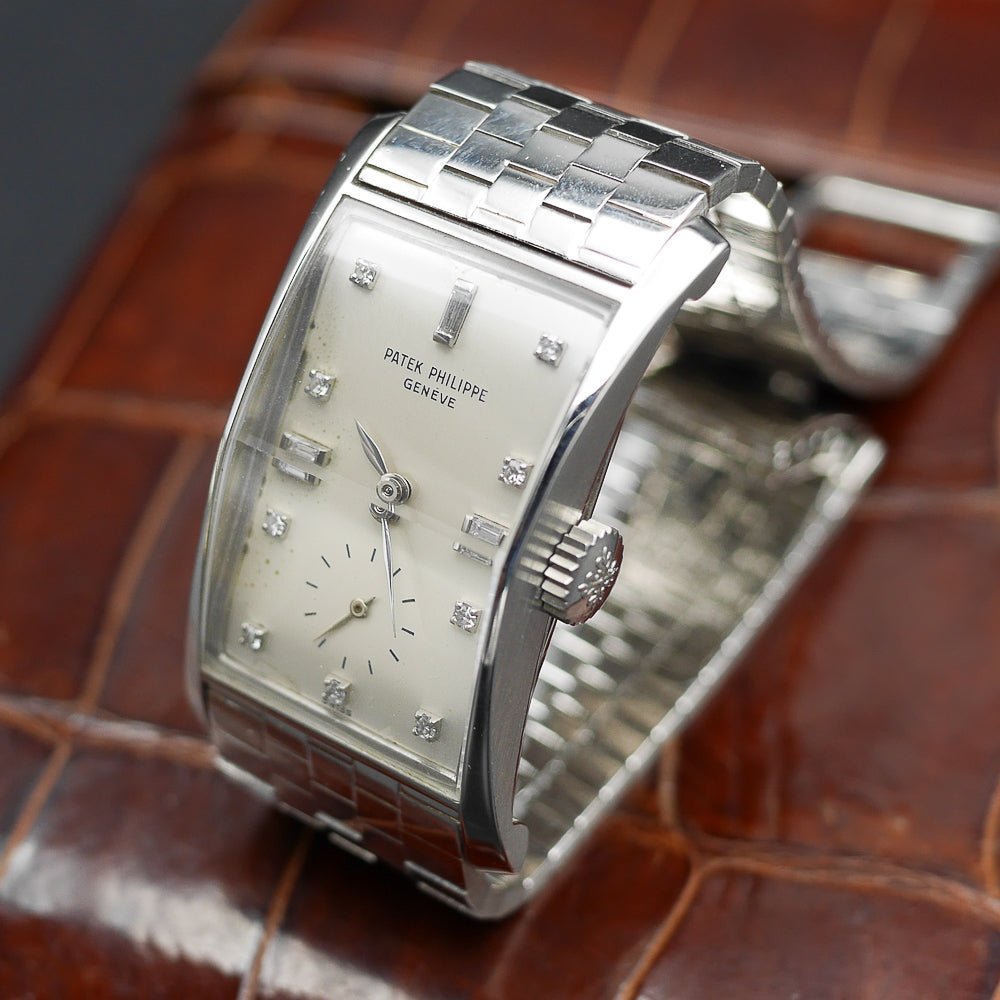 Patek Philippe Hour Glass Ref 1593 in Platinum, 1956. Oversized rectangular case, silver dial, diamond indexes. Iconic mid-century design, highly collectible.