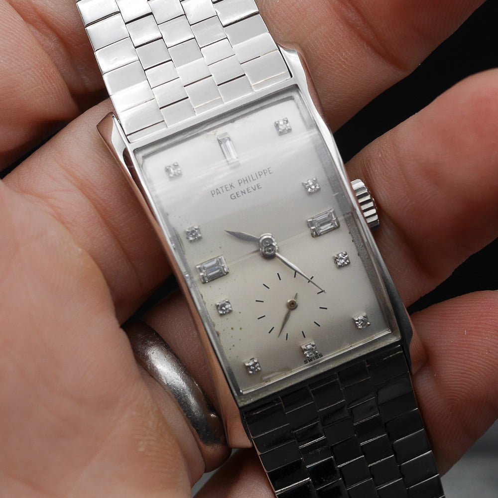 Patek Philippe Hour Glass Ref 1593 in Platinum, 1956. Oversized rectangular case, silver dial, diamond indexes. Iconic mid-century design, highly collectible.