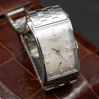 Patek Philippe Hour Glass Ref 1593 in Platinum, 1956. Oversized rectangular case, silver dial, diamond indexes. Iconic mid-century design, highly collectible.
