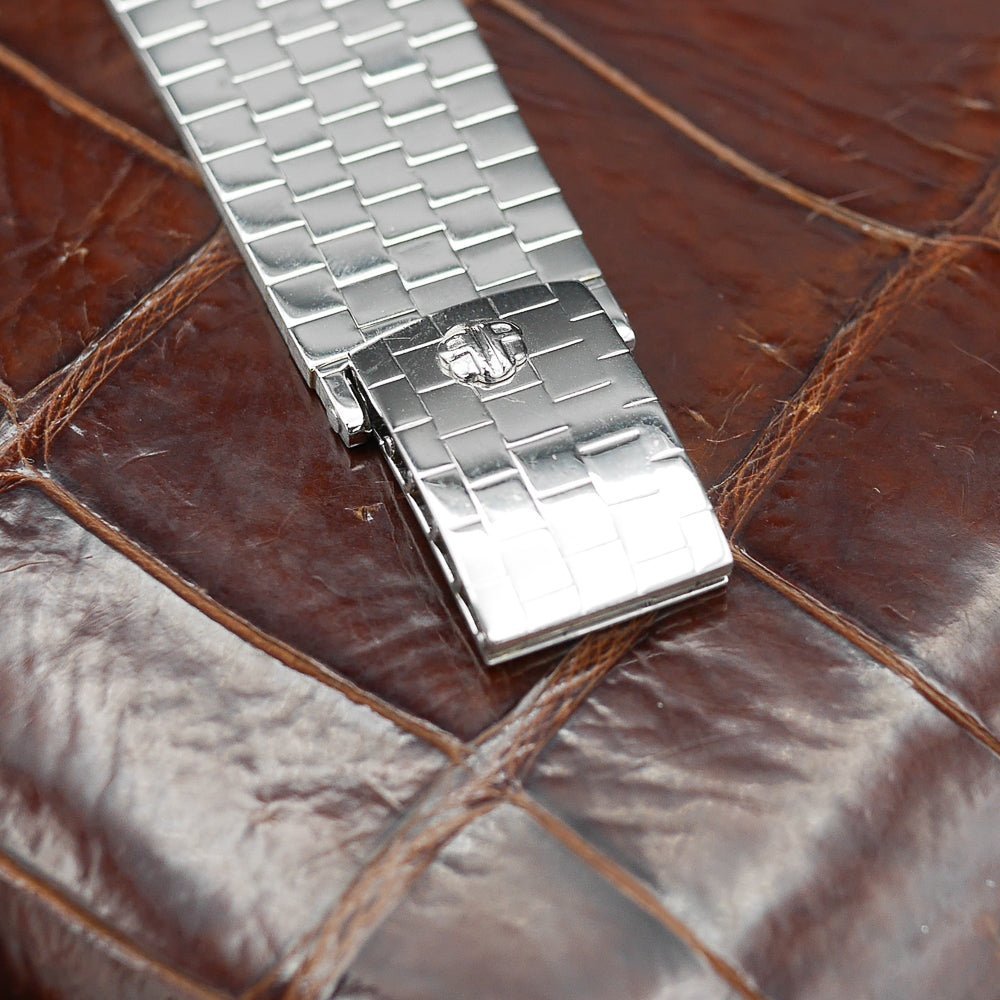Patek Philippe Hour Glass Ref 1593 in Platinum, 1956. Oversized rectangular case, silver dial, diamond indexes. Iconic mid-century design, highly collectible.