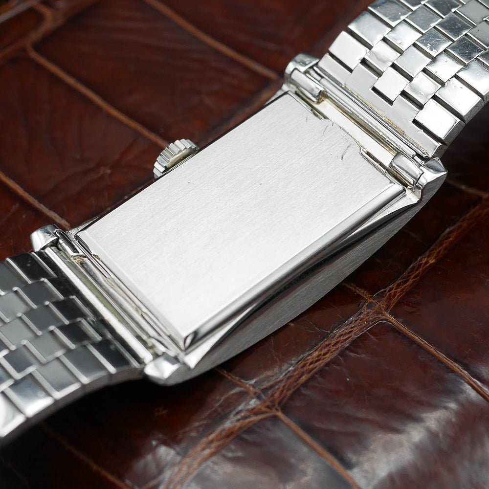 Patek Philippe Hour Glass Ref 1593 in Platinum, 1956. Oversized rectangular case, silver dial, diamond indexes. Iconic mid-century design, highly collectible.