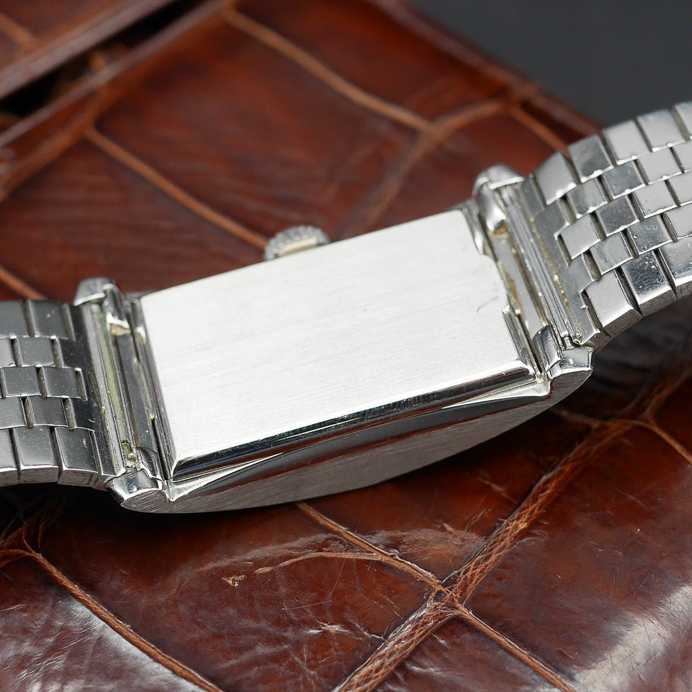 Patek Philippe Hour Glass Ref 1593 in Platinum, 1956. Oversized rectangular case, silver dial, diamond indexes. Iconic mid-century design, highly collectible.